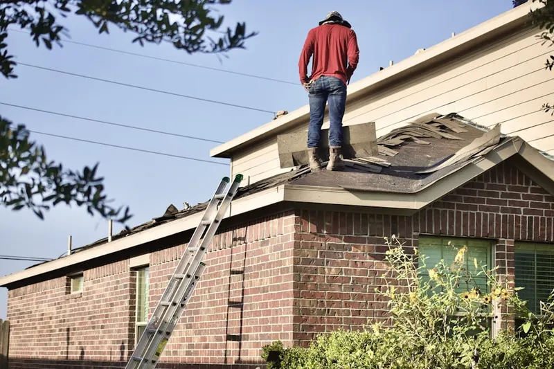 Professional roofer working on a residential roof in Irish Meeting House